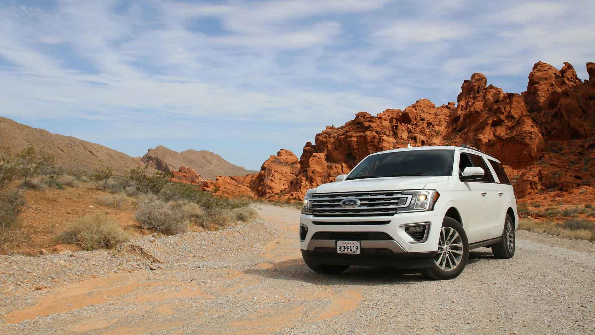Desert mountain landscape with car